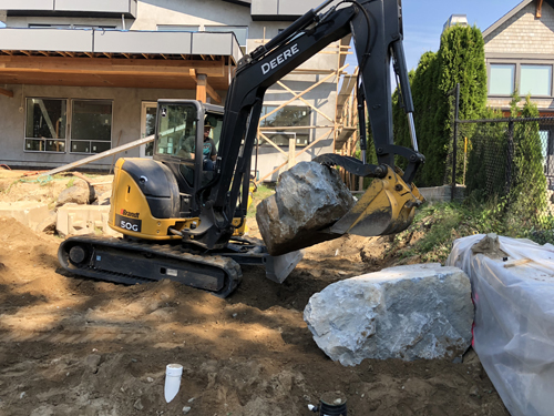 boulder wall contruction with an excavator